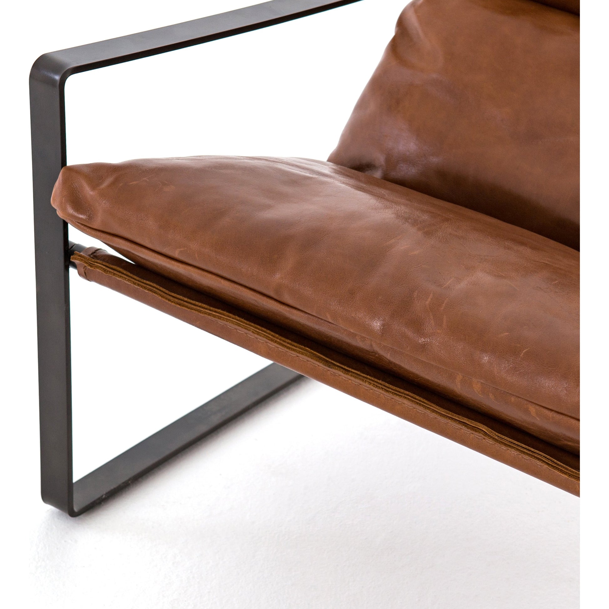 Emmett Sling Chair by Four Hands. Made from top grain leather, iron, 100% polyester in a modern style.