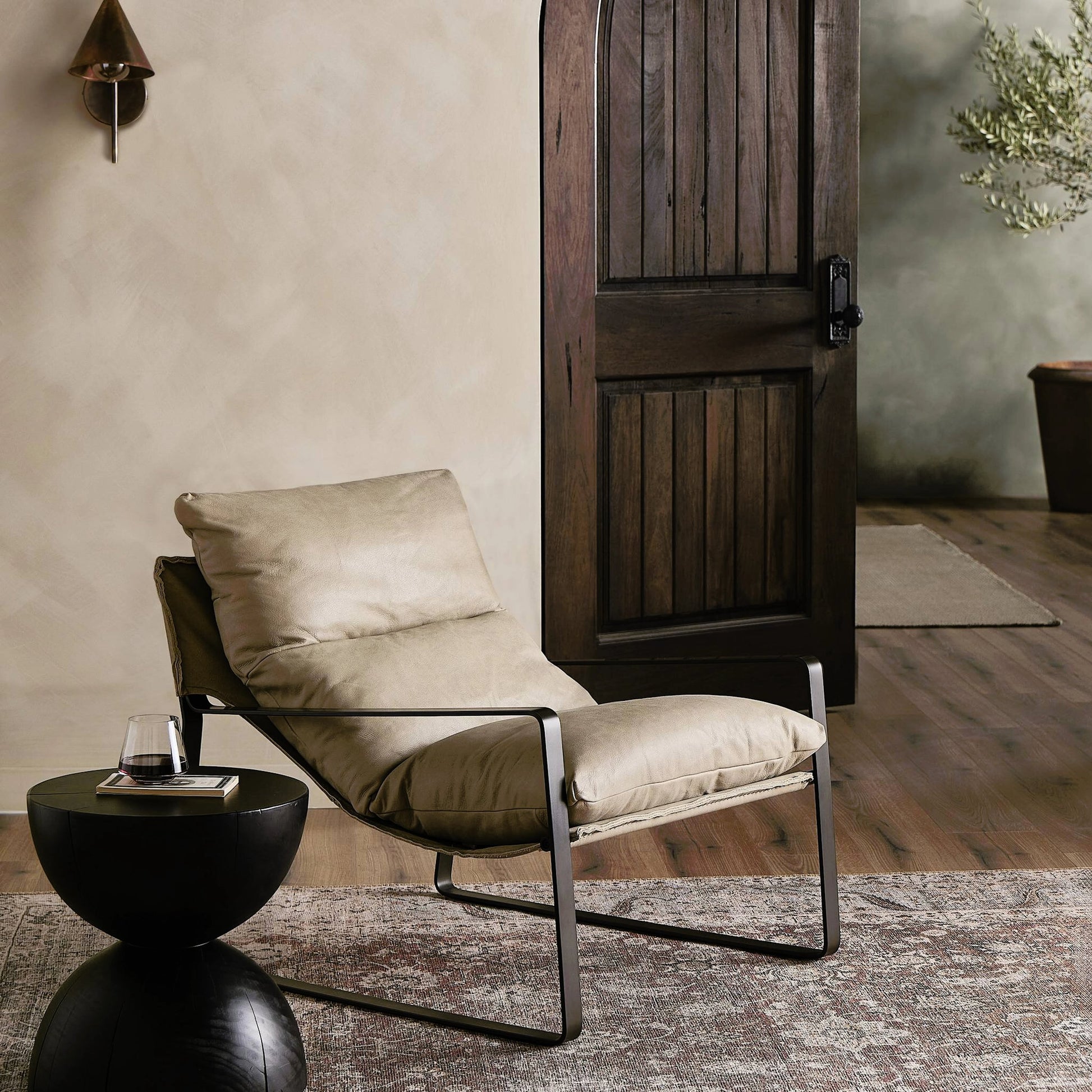 Emmett Sling Chair by Four Hands. Made from top grain leather, iron, 100% polyester in a modern style.