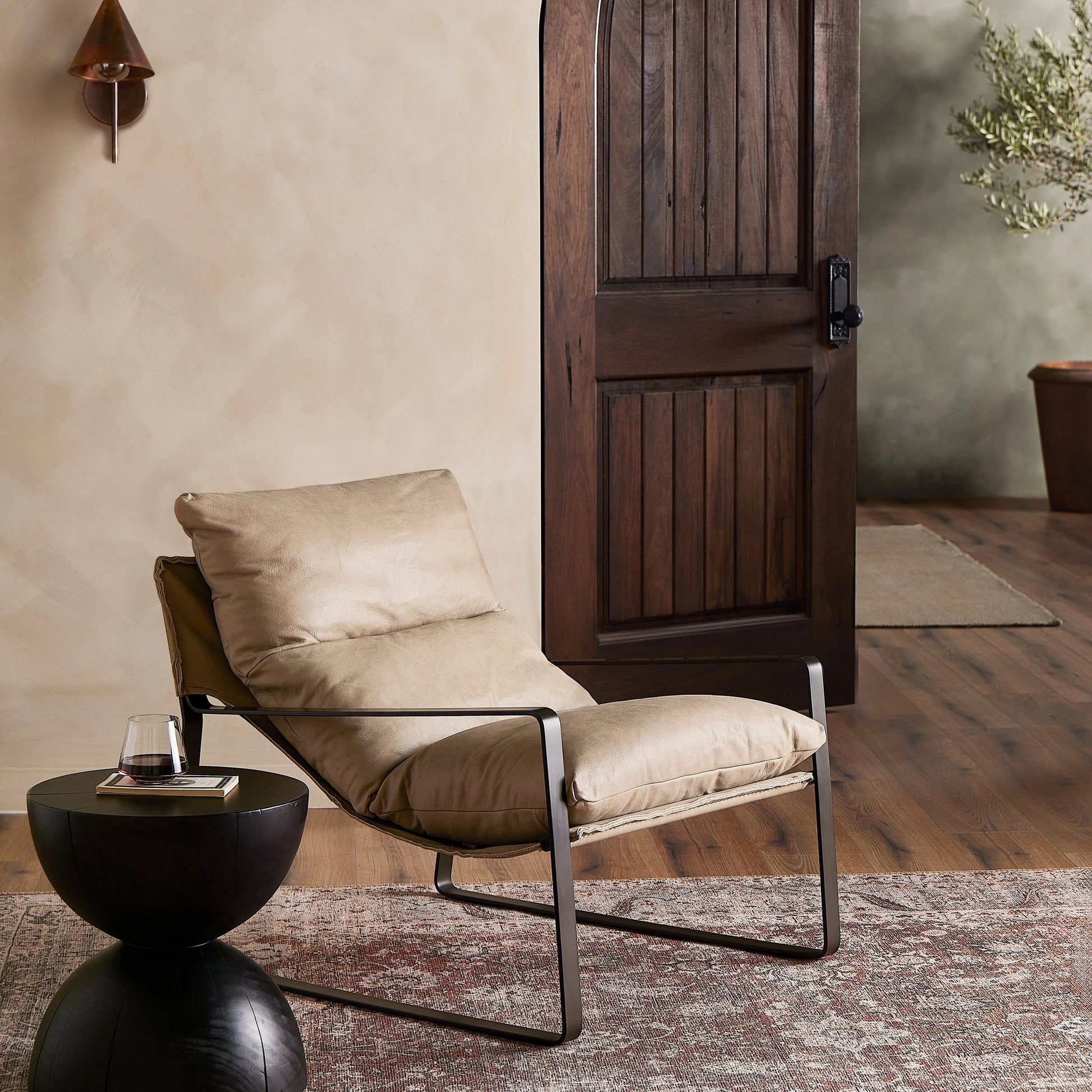 Emmett Sling Chair by Four Hands. Made from top grain leather, iron, 100% polyester in a modern style.
