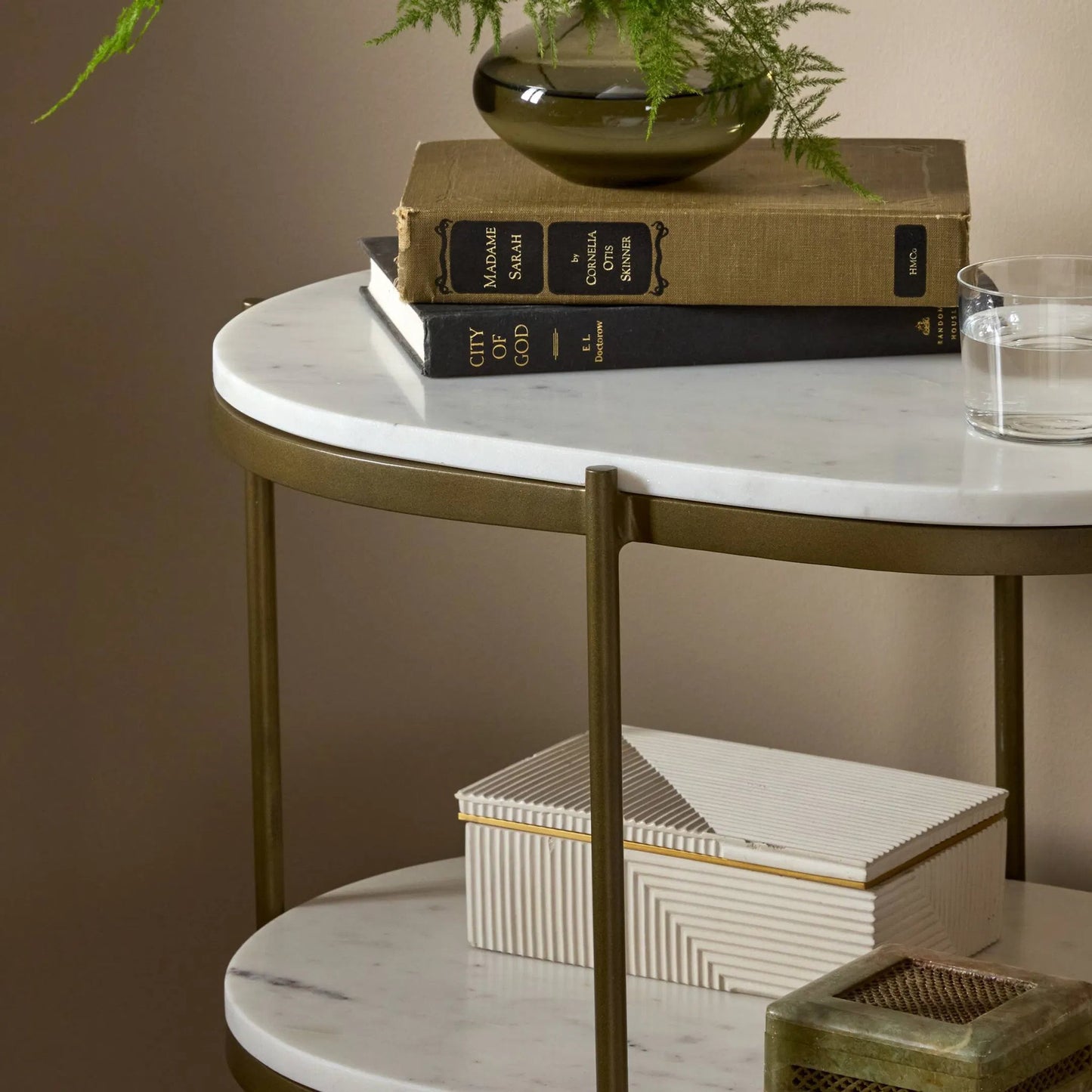 078 SI-1715263 | Closeup | Felix Oval Nightstand by Four Hands in antique brass, polished white marble. Made from iron, solid marble in a modern style.