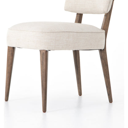 Orville Dining Chair by Four Hands in cambric ivory. Made from 90% polyester, 10% flax, linen, solid parawood, iron in a modern style.