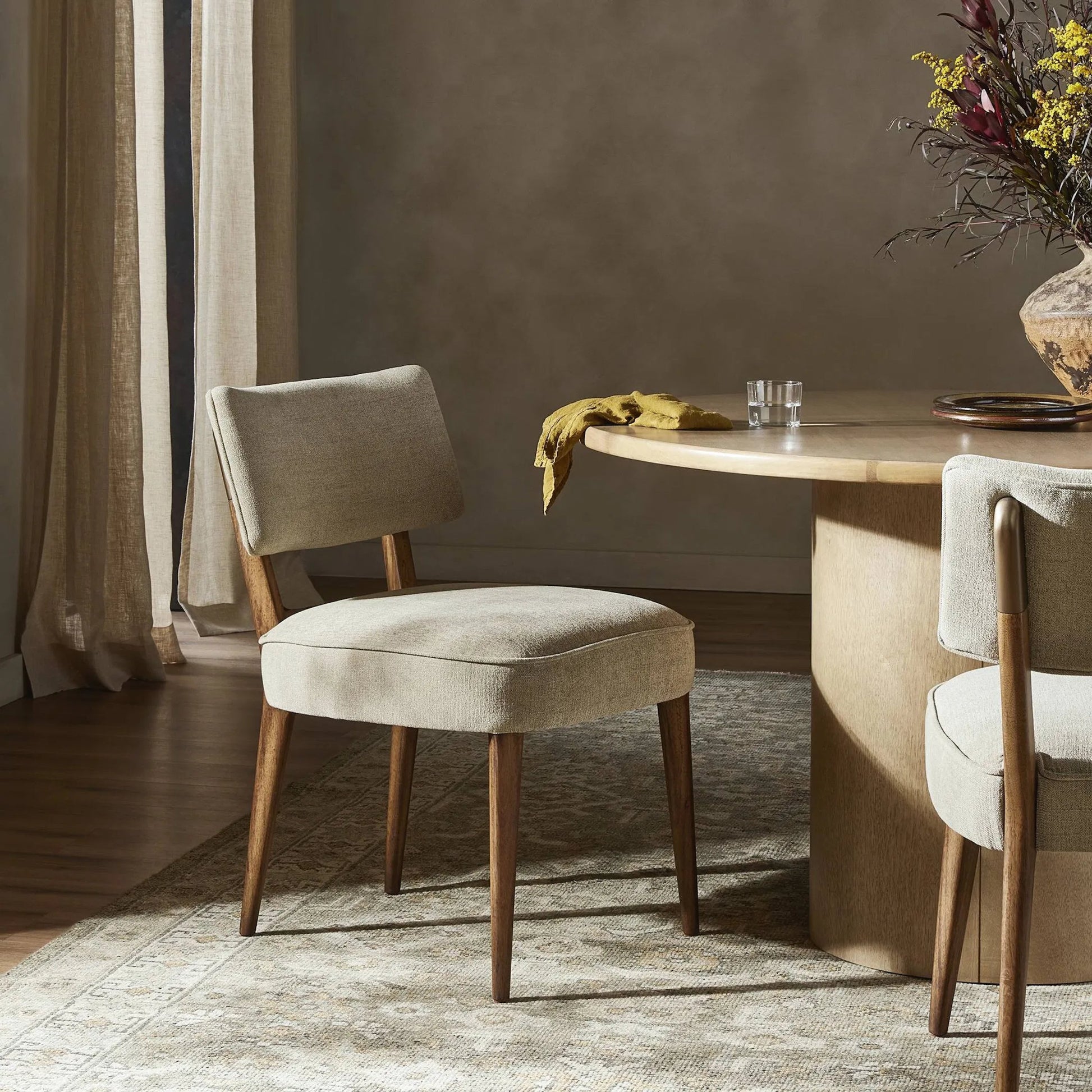 Orville Dining Chair by Four Hands in cambric ivory. Made from 90% polyester, 10% flax, linen, solid parawood, iron in a modern style.