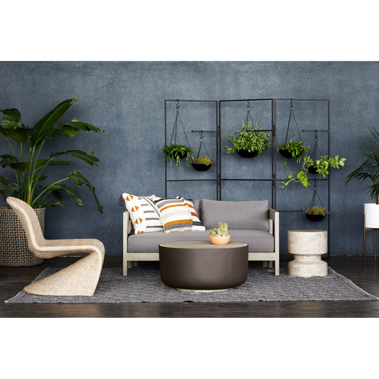 Nahla Outdoor End Table by Four Hands in graphite. Made from concrete in a modern style.
