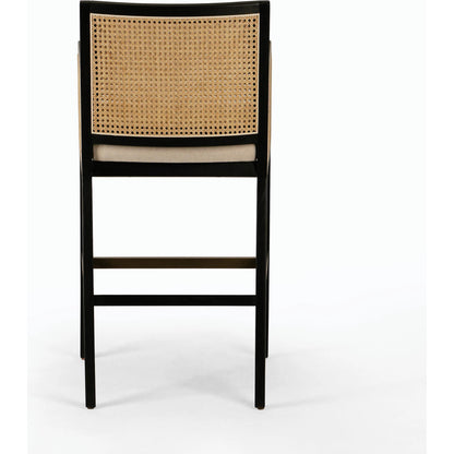 Antonia Bar Stool by Four Hands in light natural cane, brushed ebony, brass kickplate, savile flax. Made from 92% polyester, 8% flax, linen, solid nettlewood, iron in a modern style.