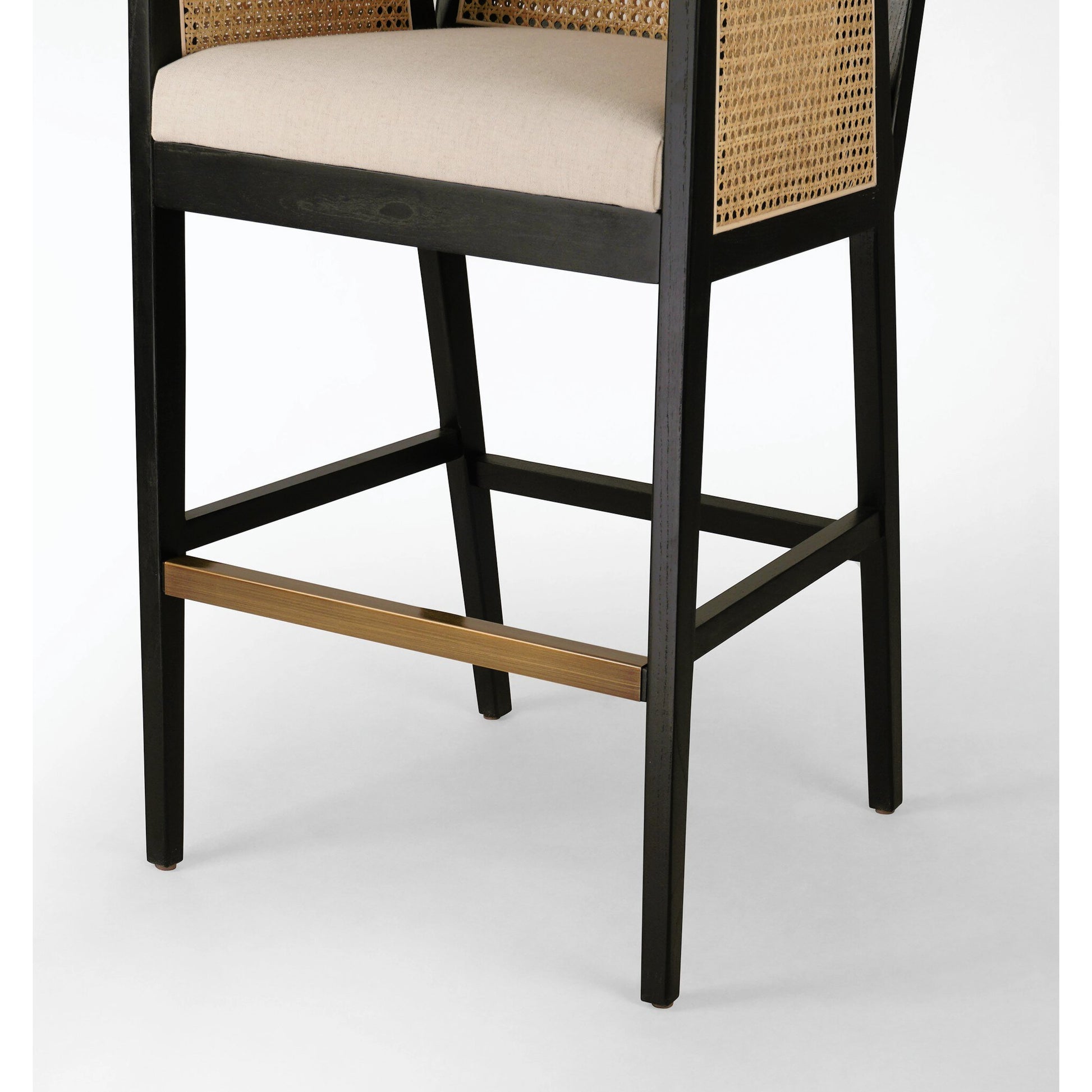 Antonia Bar Stool by Four Hands in light natural cane, brushed ebony, brass kickplate, savile flax. Made from 92% polyester, 8% flax, linen, solid nettlewood, iron in a modern style.