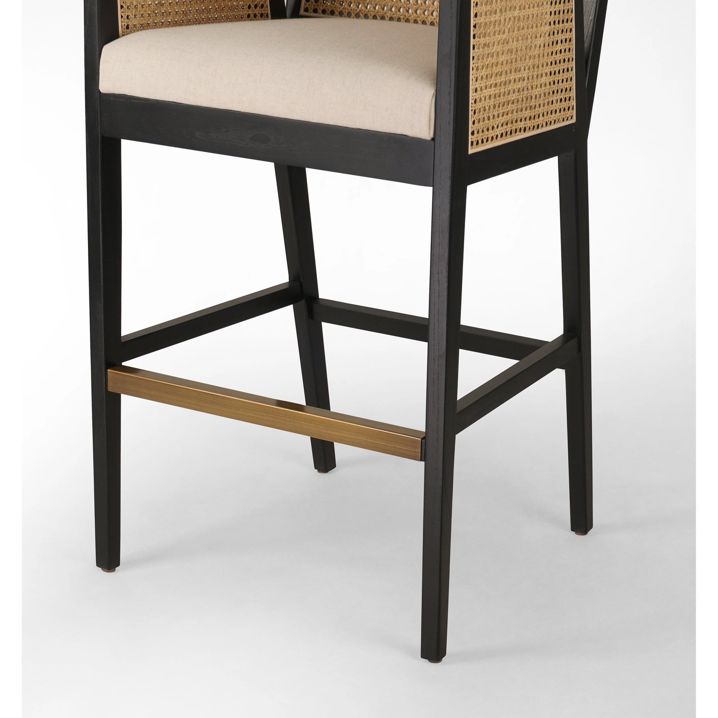 010 SI-1980072 | Closeup | Antonia Bar Stool by Four Hands in light natural cane, brushed ebony, brass kickplate, savile flax. Made from 92% polyester, 8% flax, linen, solid nettlewood, iron in a modern style.