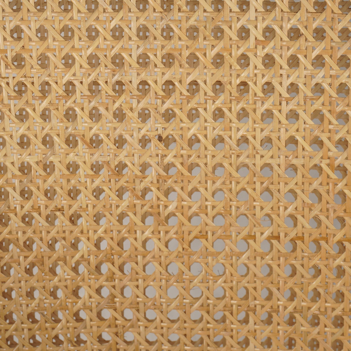 011 SI-1980072 | Closeup | Antonia Bar Stool by Four Hands in light natural cane, brushed ebony, brass kickplate, savile flax. Made from 92% polyester, 8% flax, linen, solid nettlewood, iron in a modern style.