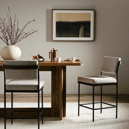 Benton Bar + Counter Stool by Four Hands in savile flannel and almond, midnight iron. Made from 92% polyester, 8% flax, linen, solid nettlewood, iron in a modern style.