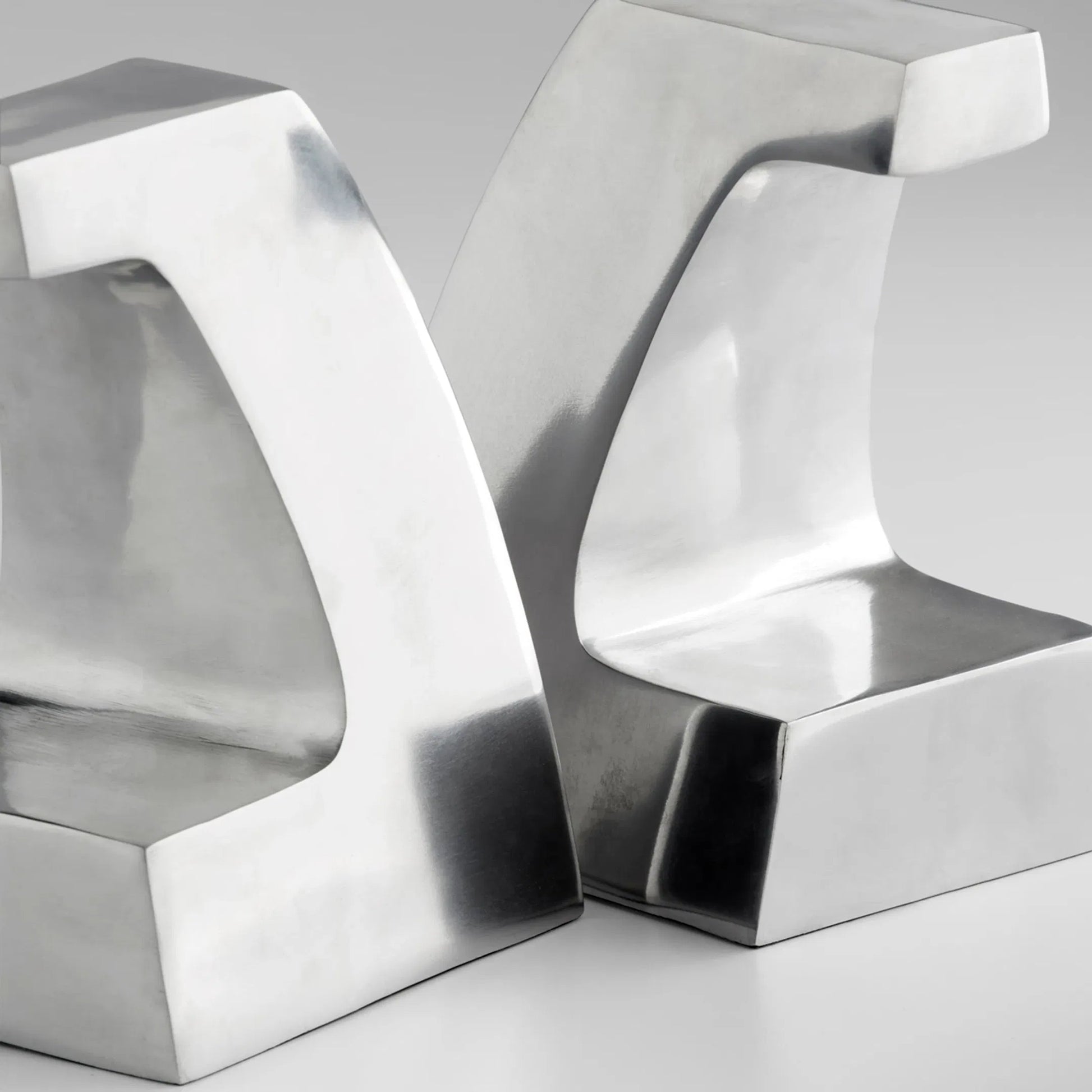 Apostrophe Bookends in Polished Aluminum by Cyan Design in polished aluminum. Made from unique in a modern style.