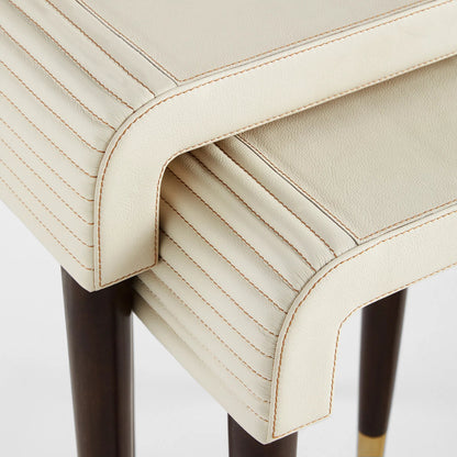 Channel Nesting Tables (Set of 2) by Cyan Design in off white, walnut. Made from leather, mdf, brass in a transitional style.