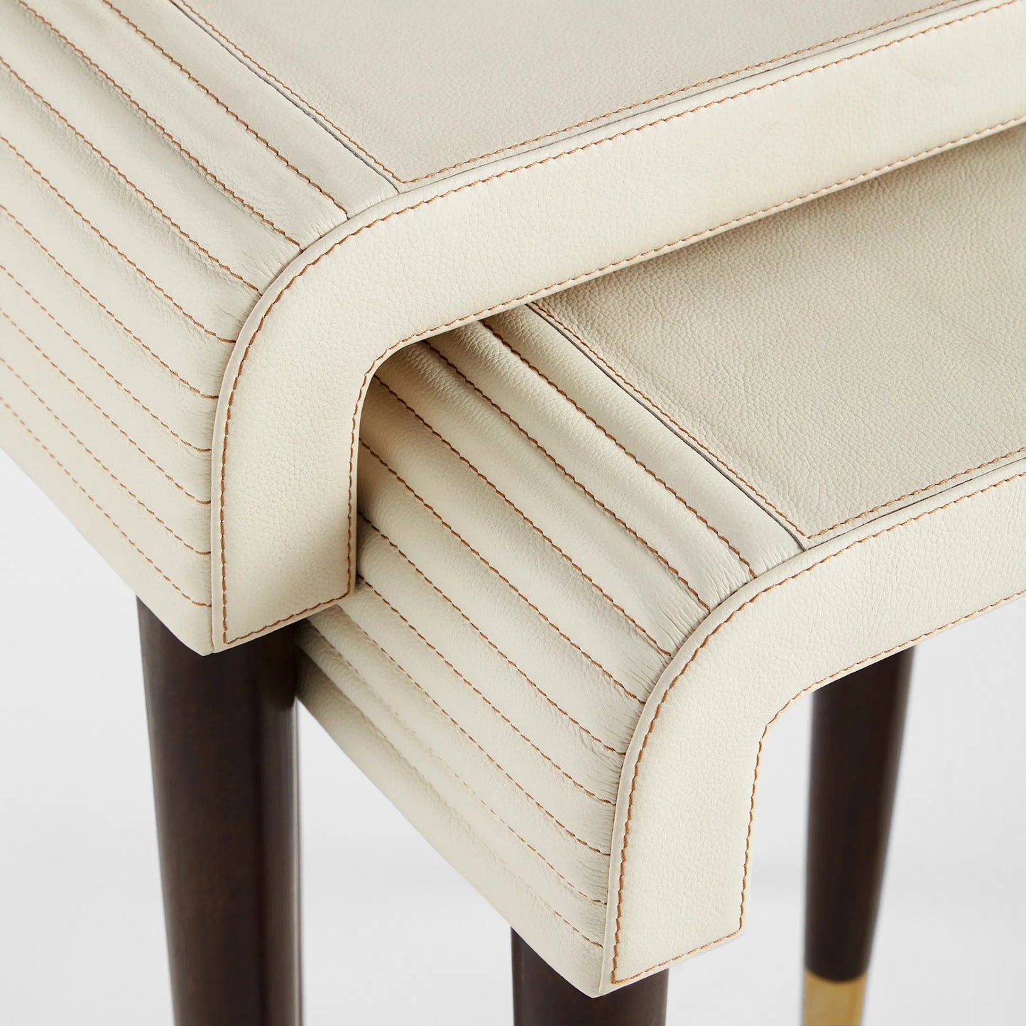 002 SI-2328575 | Closeup | Channel Nesting Tables (Set of 2) by Cyan Design in off white, walnut. Made from leather, mdf, brass in a transitional style.