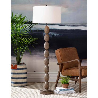 Buoy Floor Lamp by Regina Andrew in brown. Made from birch wood in a coastal style.