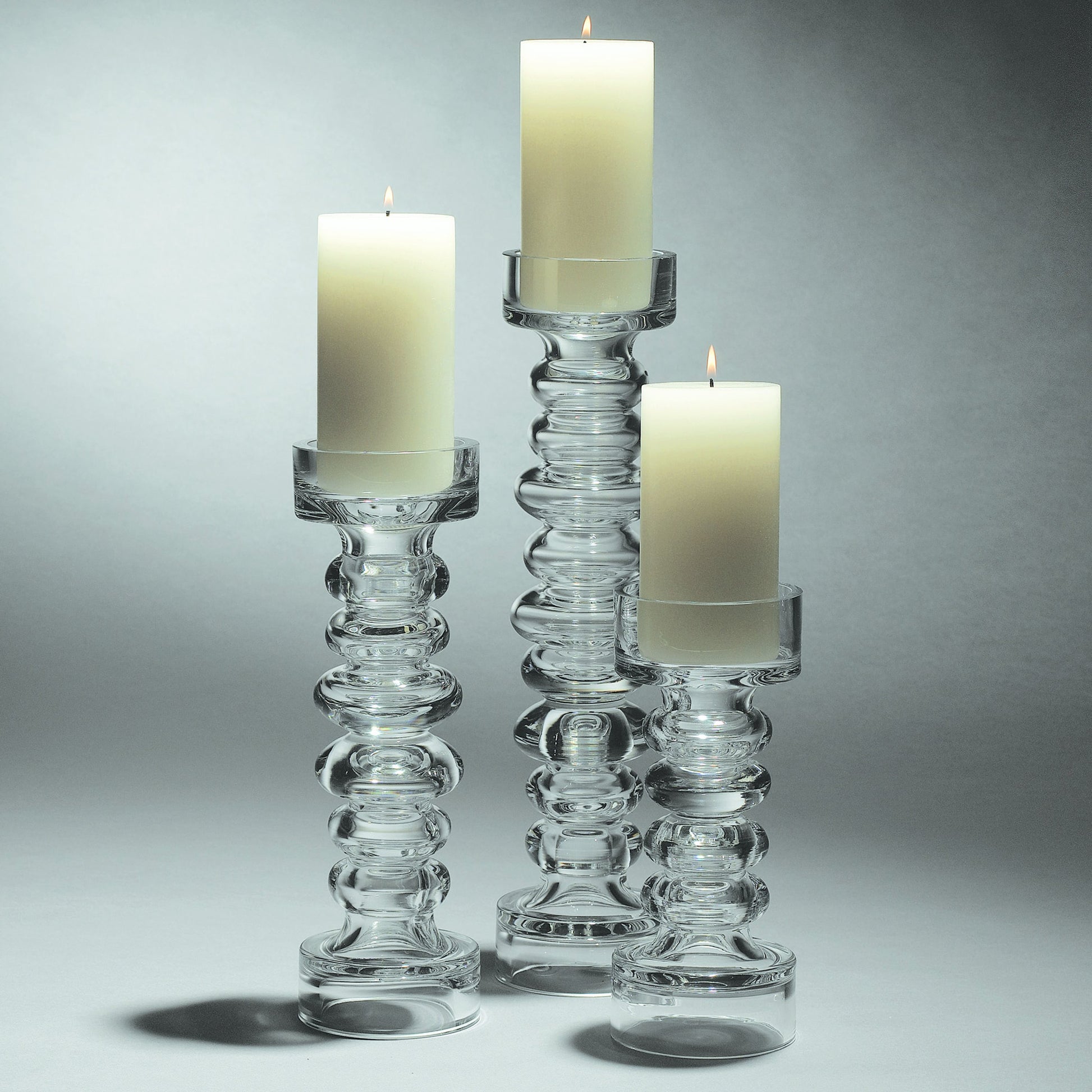 Glass Ribbed Candleholder by Global Views. Made from glass in a transitional style.