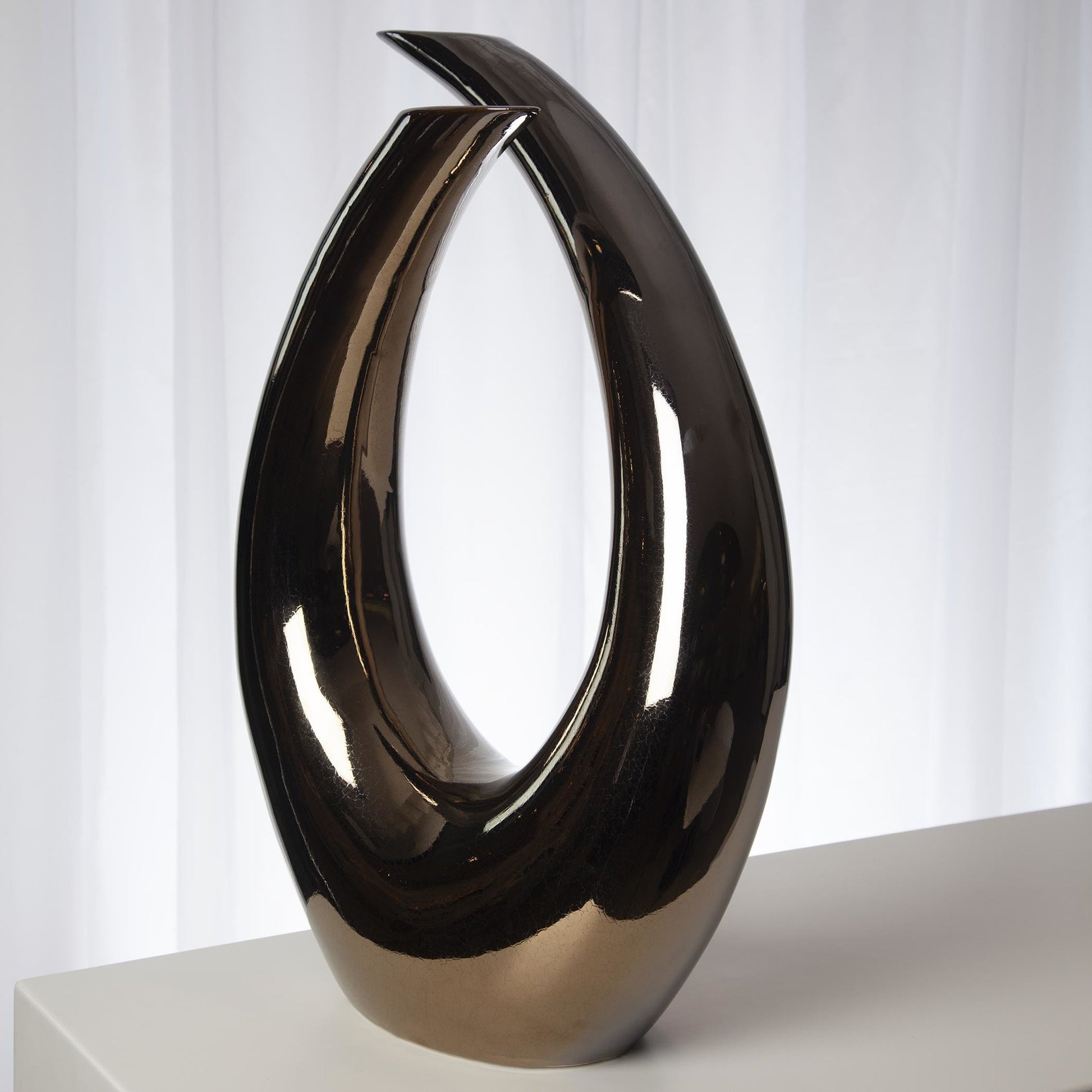 Loop Sculpture by Global Views. Made from ceramic in a modern style.