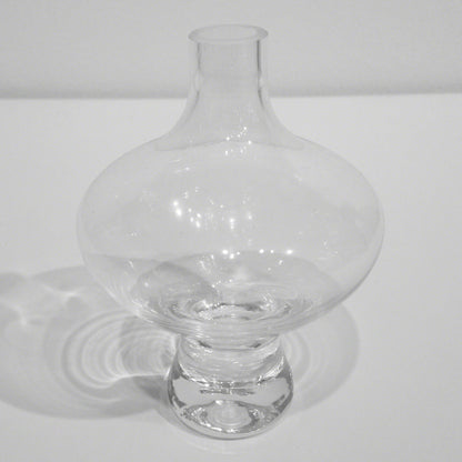 Mini Floating Footed Vase by Global Views. Made from glass in a modern style.