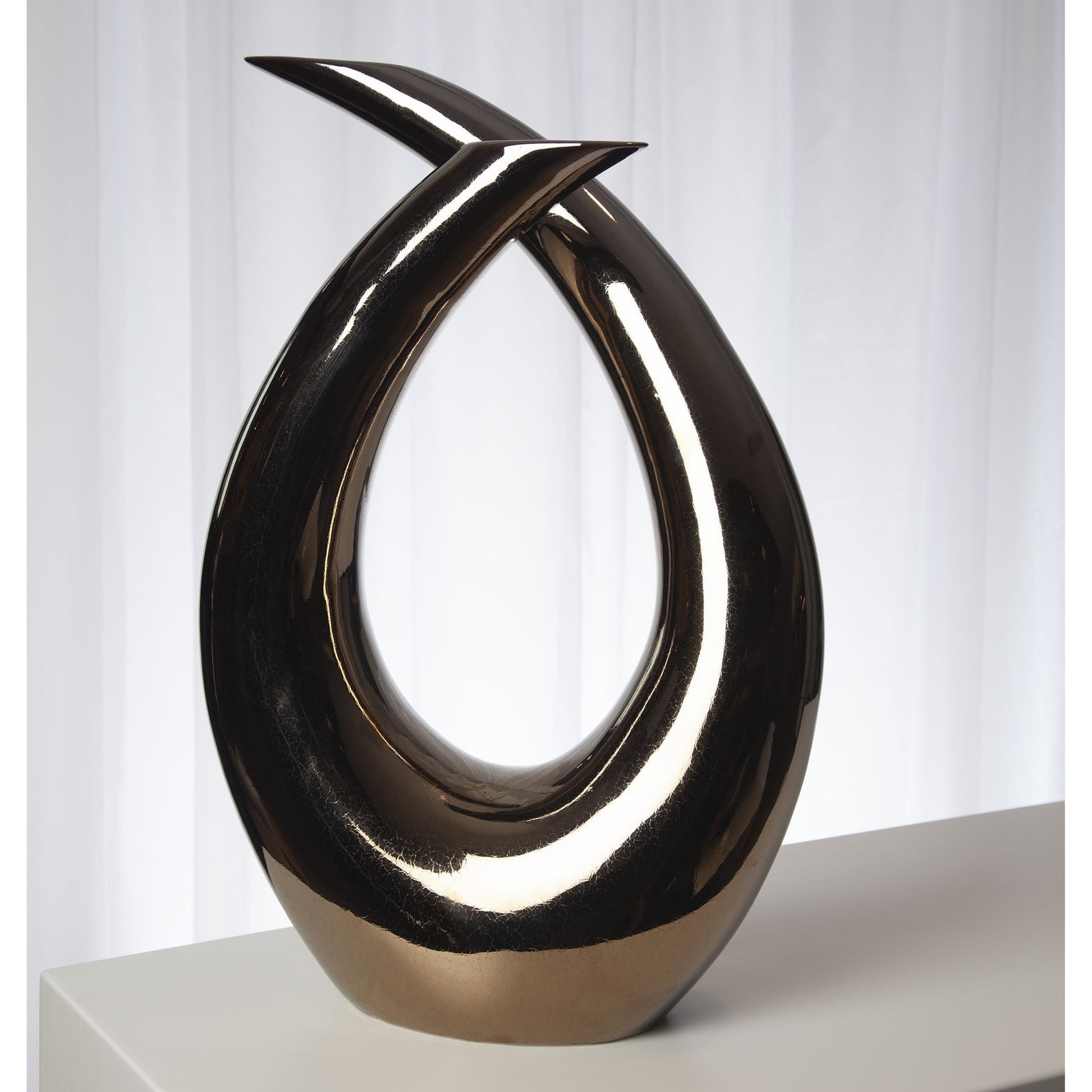 Loop Sculpture by Global Views. Made from ceramic in a modern style.