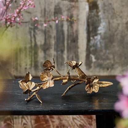 Dogwood Sprig by Regina Andrew in antique gold leaf. Made from steel in a modern style.