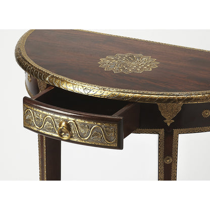 Ranthore Demilune Console Table by Butler Specialty Company in dark brown and artifacts. Made from mango wood solids, brass foil in a traditional style.