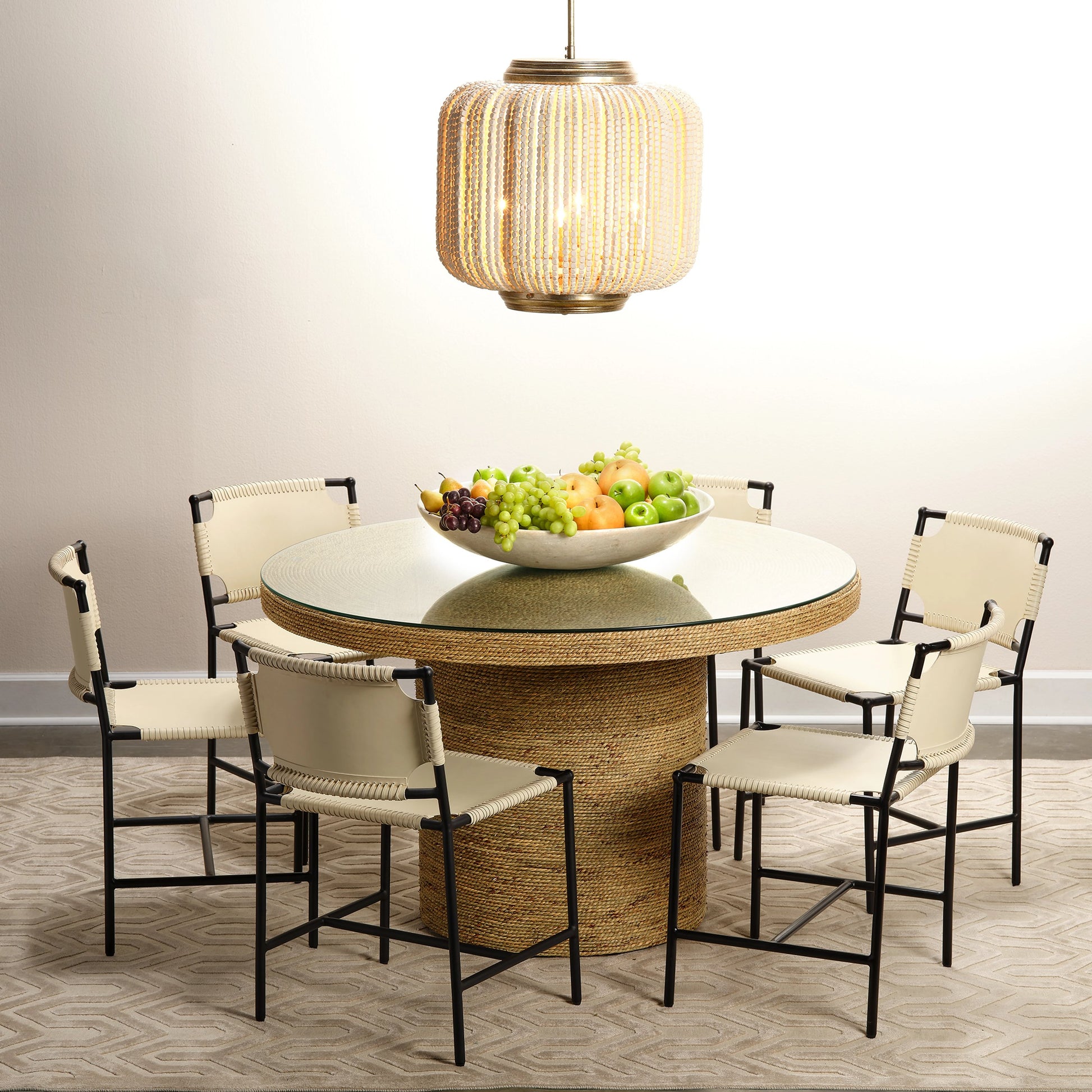 Harbor Round Bistro Table by Jamie Young. Made from seagrass with tempered glass in a coastal style.