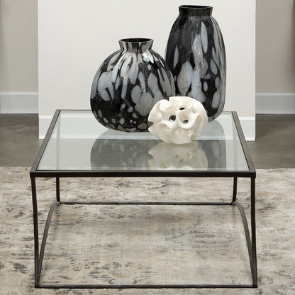 Kai Coffee Table by Jamie Young in black. Made from forged iron, clear tempered glass top in a modern style.