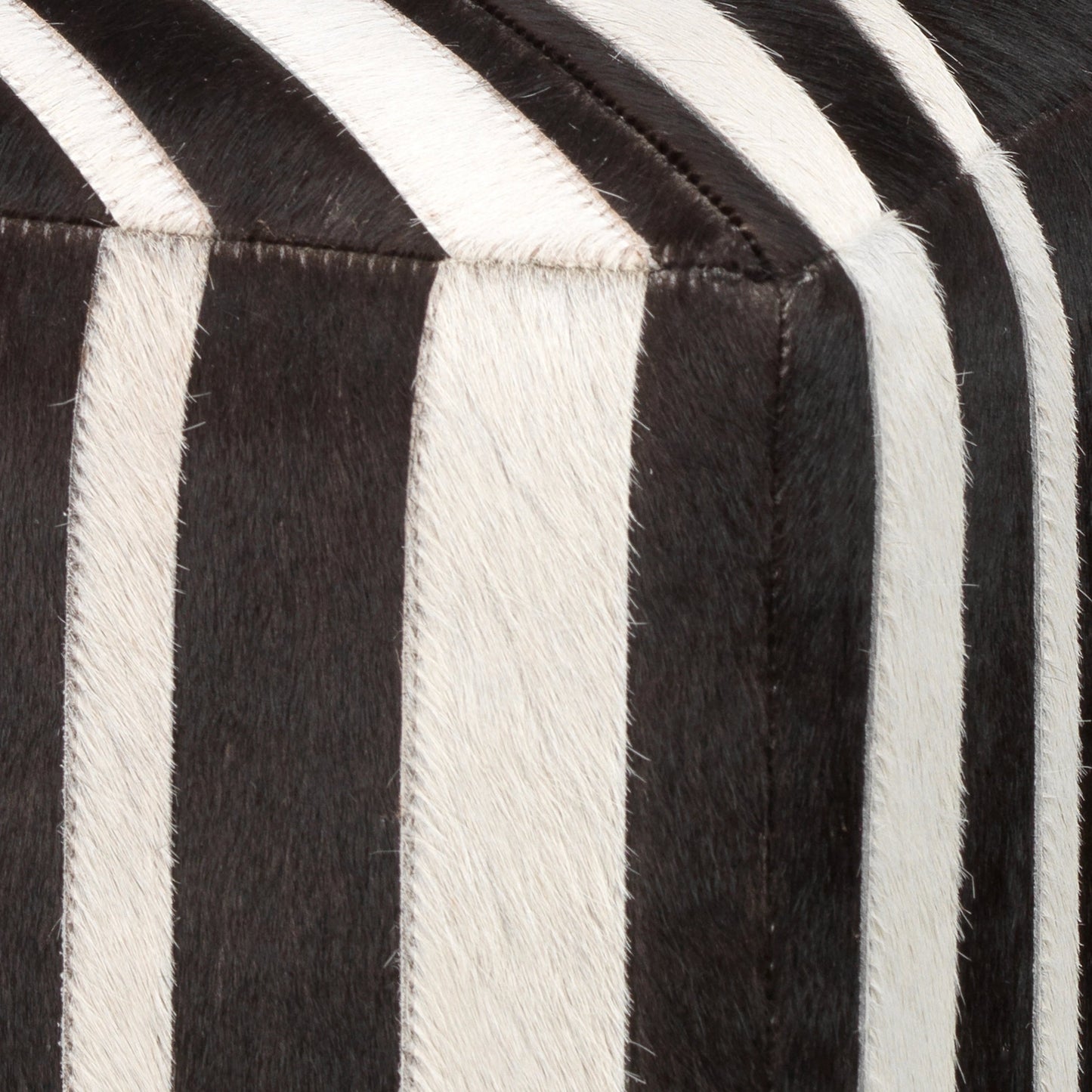 001 SI-1719687 | Closeup | Nantucket Criss Cross Ottoman by Jamie Young in espresso. Made from hair on hide in a modern style.