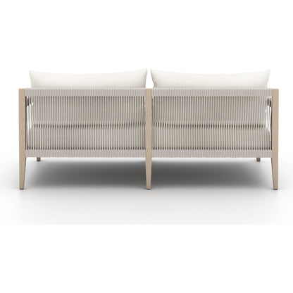 Sherwood Outdoor Sofa, Washed Brown by Four Hands. Made from 100% olefin, solid fsc®-certified teak, 100% polypropylene in a coastal style.