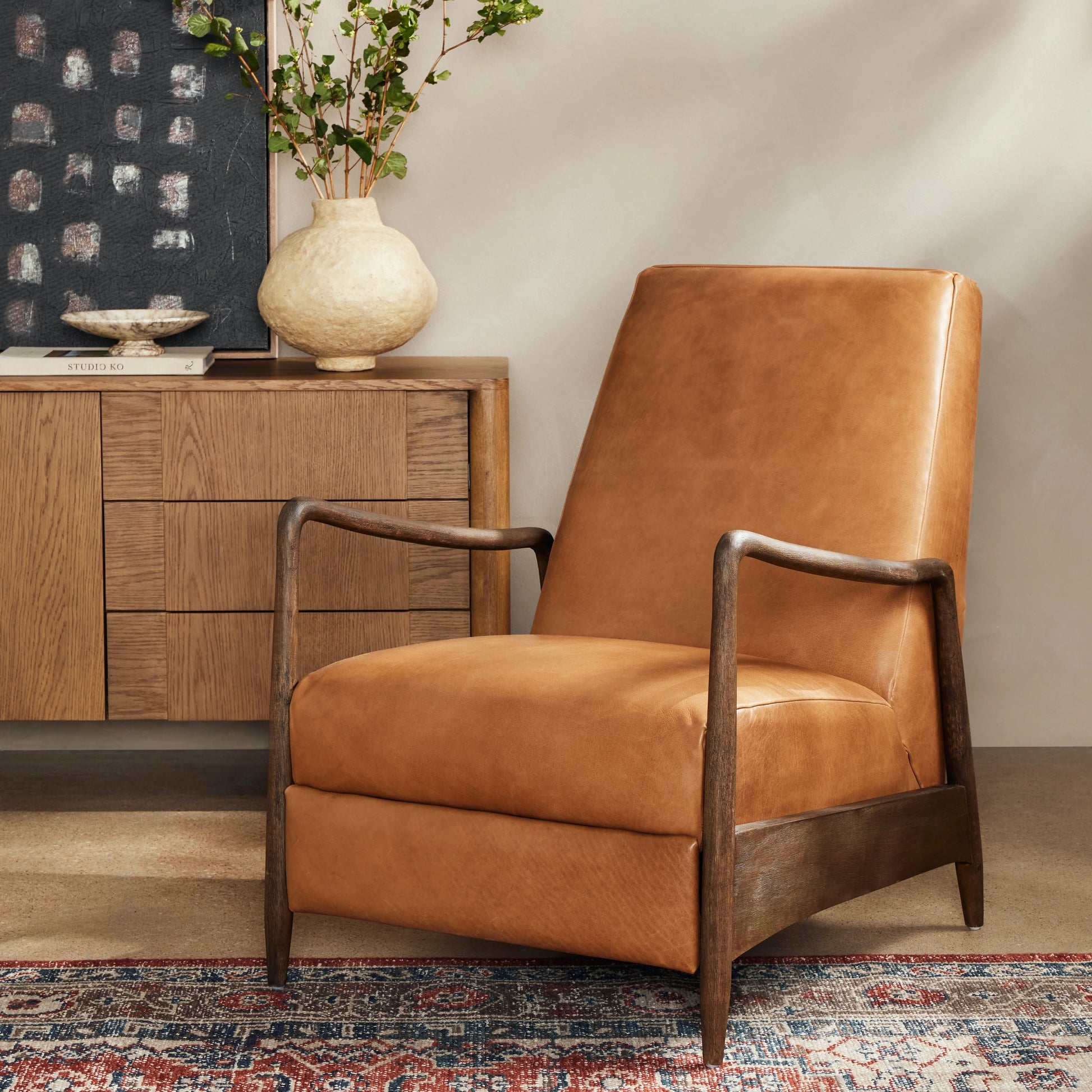 Braden Recliner by Four Hands in dakota black, rubbed sienna brown. Made from top grain leather, solid parawood, 100% polyester in a modern style.