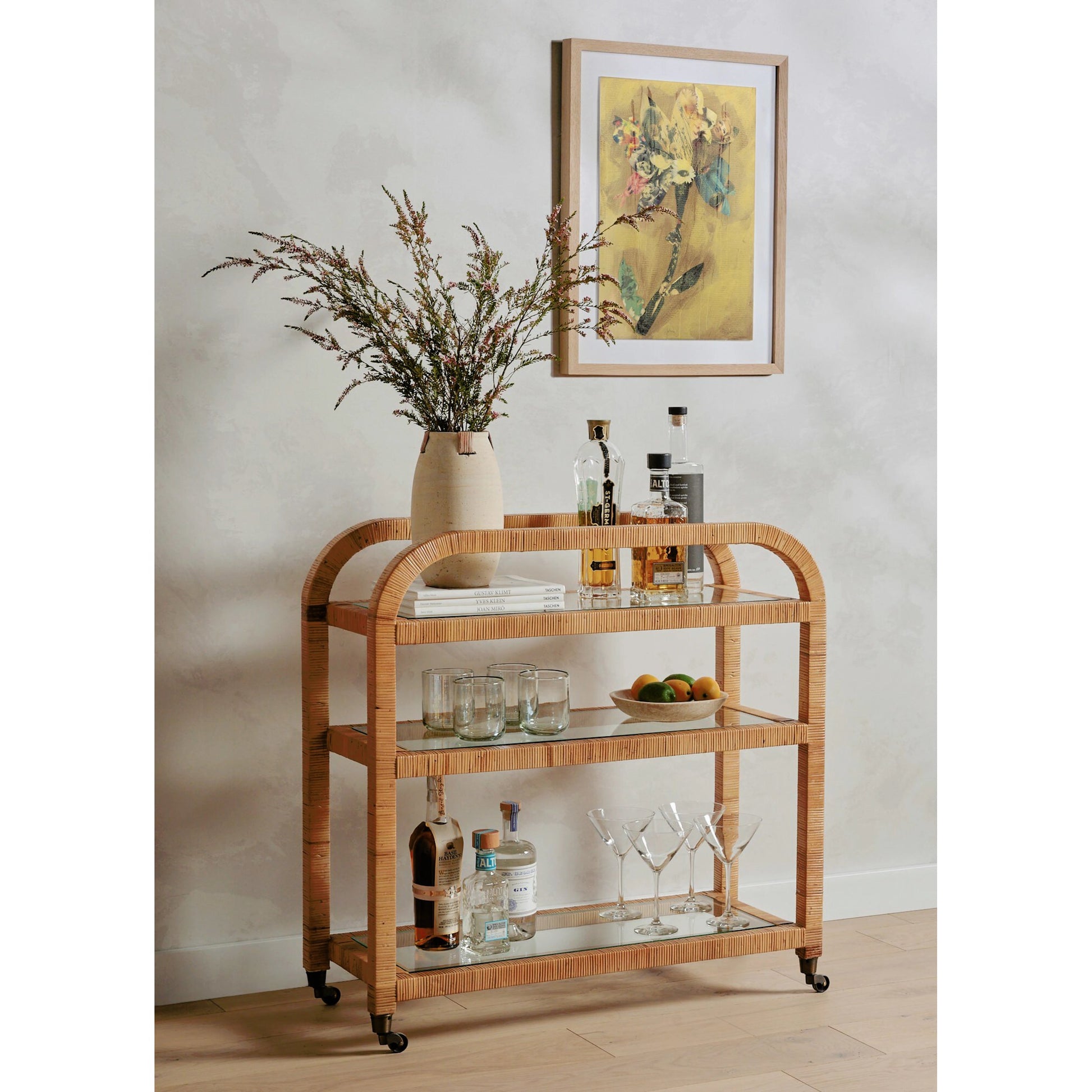 Dory Bar Cart by Four Hands in honey. Made from rattan, tempered glass, solid mahogany in a modern style.