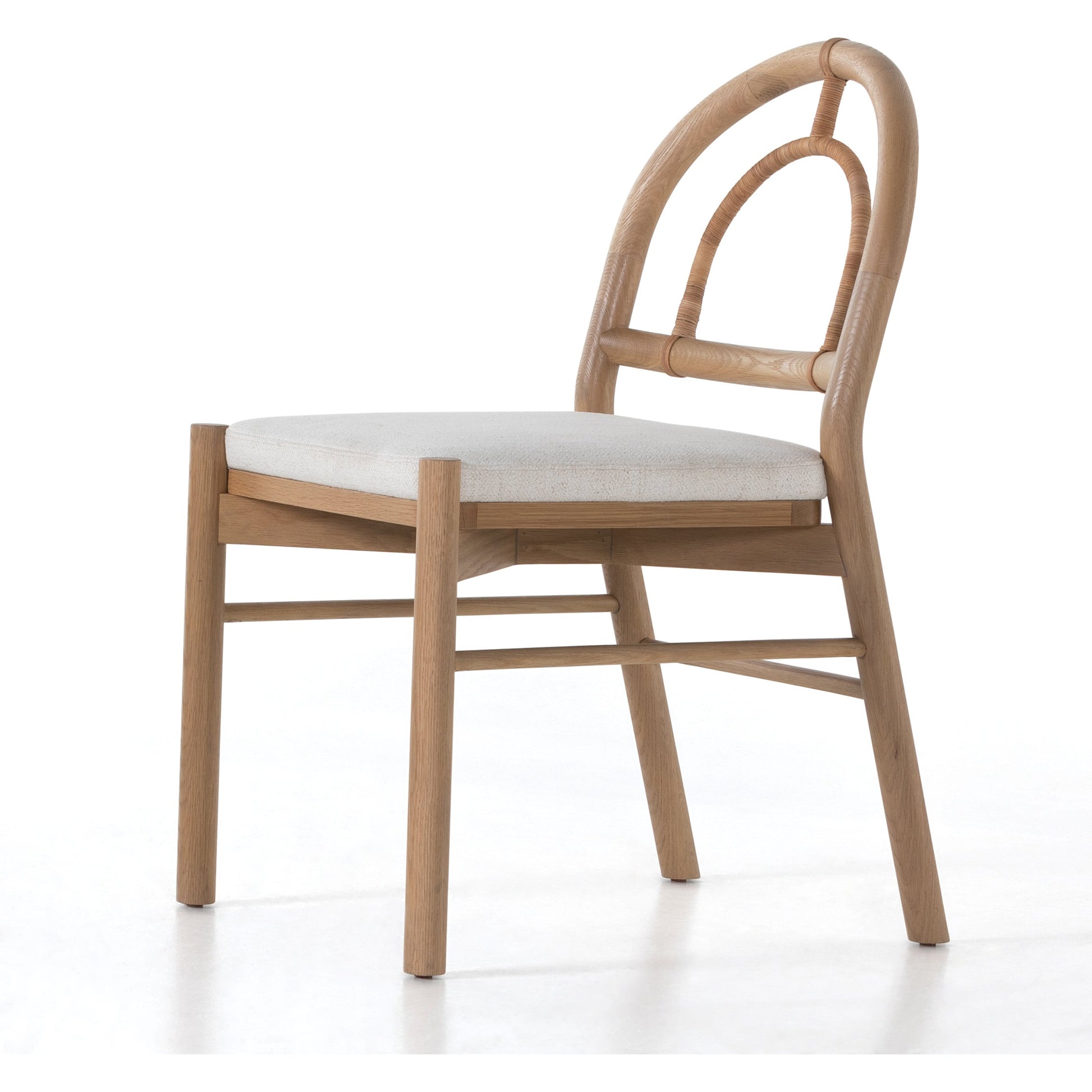 Pace Dining Chair by Four Hands in natural cane, dover crescent and burnished oak. Made from 71% viscose (rayon), 17% polyester, 12% flax, linen, solid oak, cane in a coastal style.