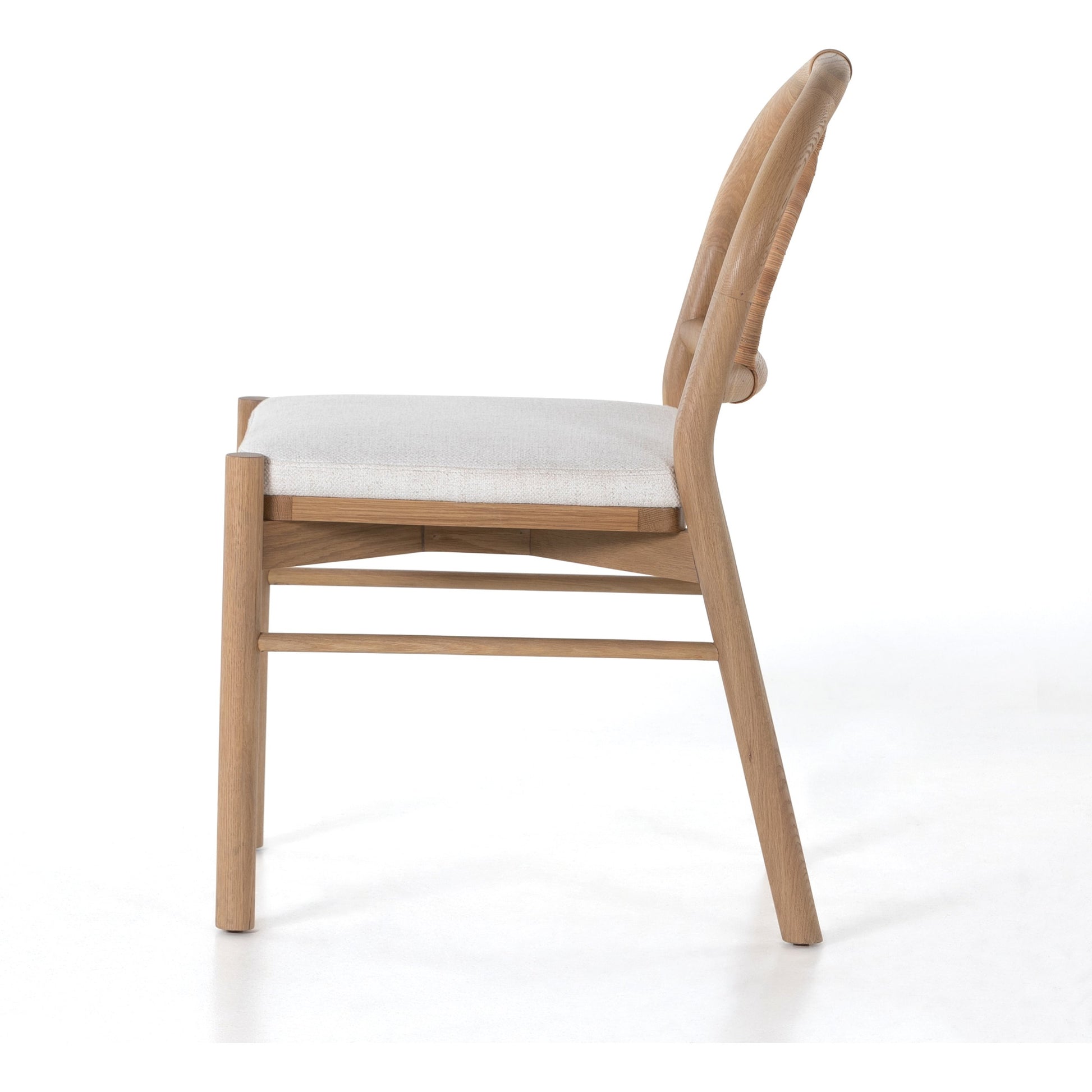 Pace Dining Chair by Four Hands in natural cane, dover crescent and burnished oak. Made from 71% viscose (rayon), 17% polyester, 12% flax, linen, solid oak, cane in a coastal style.