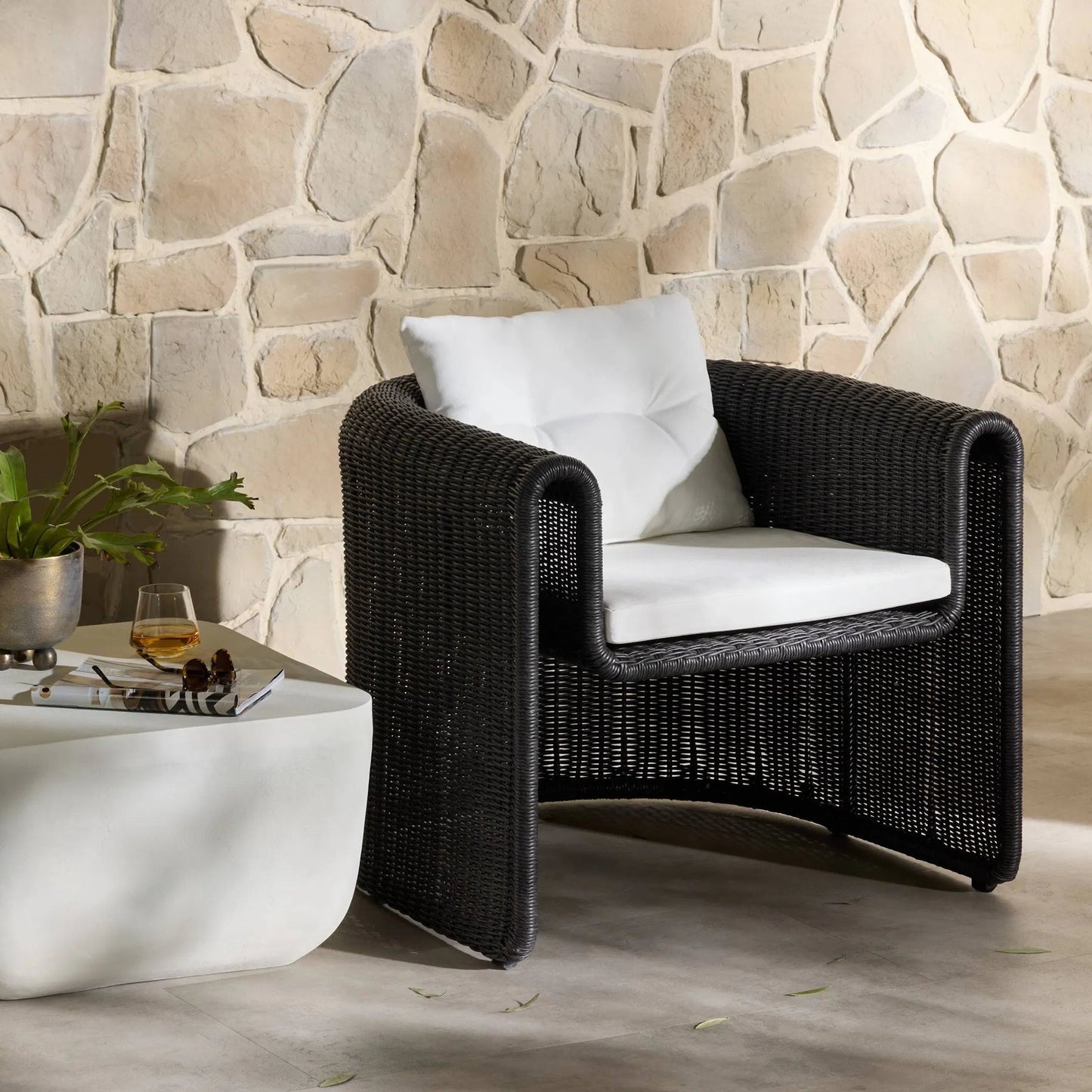 039 SI-1717070 | Lifestyle | Tucson Woven Outdoor Chair by Four Hands. Made from 100% olefin, 100% polyethylene, iron in a coastal style.
