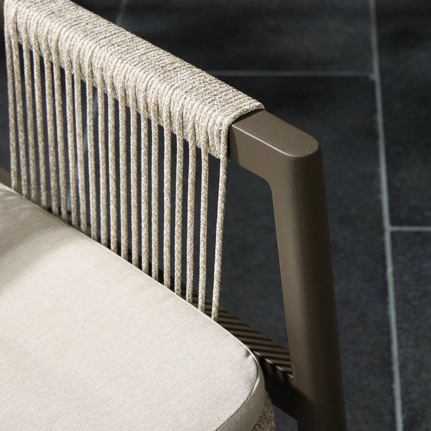 008 SI-1716745 | Closeup | Shuman Outdoor Dining Chair by Four Hands in stone grey, bronze, heathered grey rope and stone gray. Made from 100% olefin, aluminum, 100% polypropylene in a modern style.