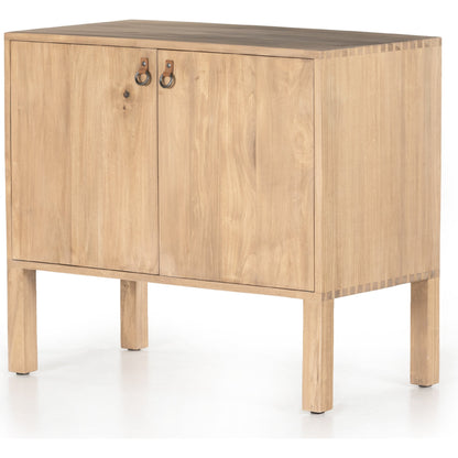 Isador Bar Cabinet by Four Hands in black wash poplar, natural iron, black leather and black wash poplar. Made from solid poplar, top grain leather in a modern style.