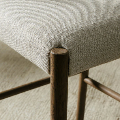 Glenmore Counter Stool by Four Hands in essence natural. Made from 49% viscose (rayon), 22% flax, linen, 18% polyester, 11% cotton, solid oak, 100% polyurethane foam pad in a modern style.