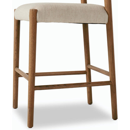 Glenmore Counter Stool by Four Hands in essence natural. Made from 49% viscose (rayon), 22% flax, linen, 18% polyester, 11% cotton, solid oak, 100% polyurethane foam pad in a modern style.