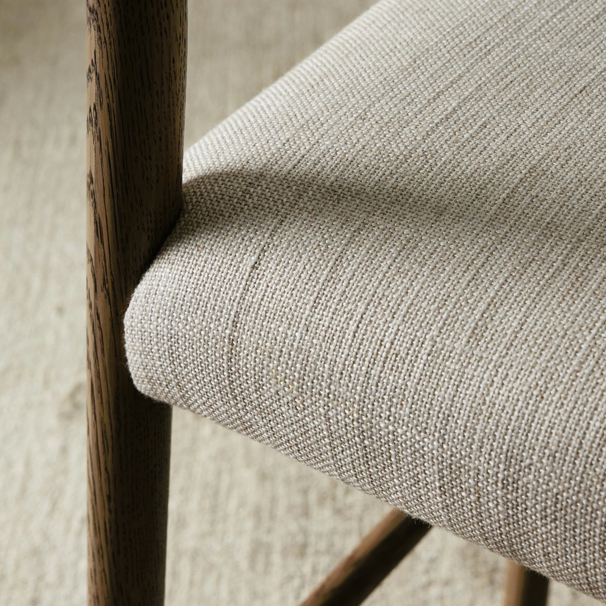 Glenmore Counter Stool by Four Hands in essence natural. Made from 49% viscose (rayon), 22% flax, linen, 18% polyester, 11% cotton, solid oak, 100% polyurethane foam pad in a modern style.