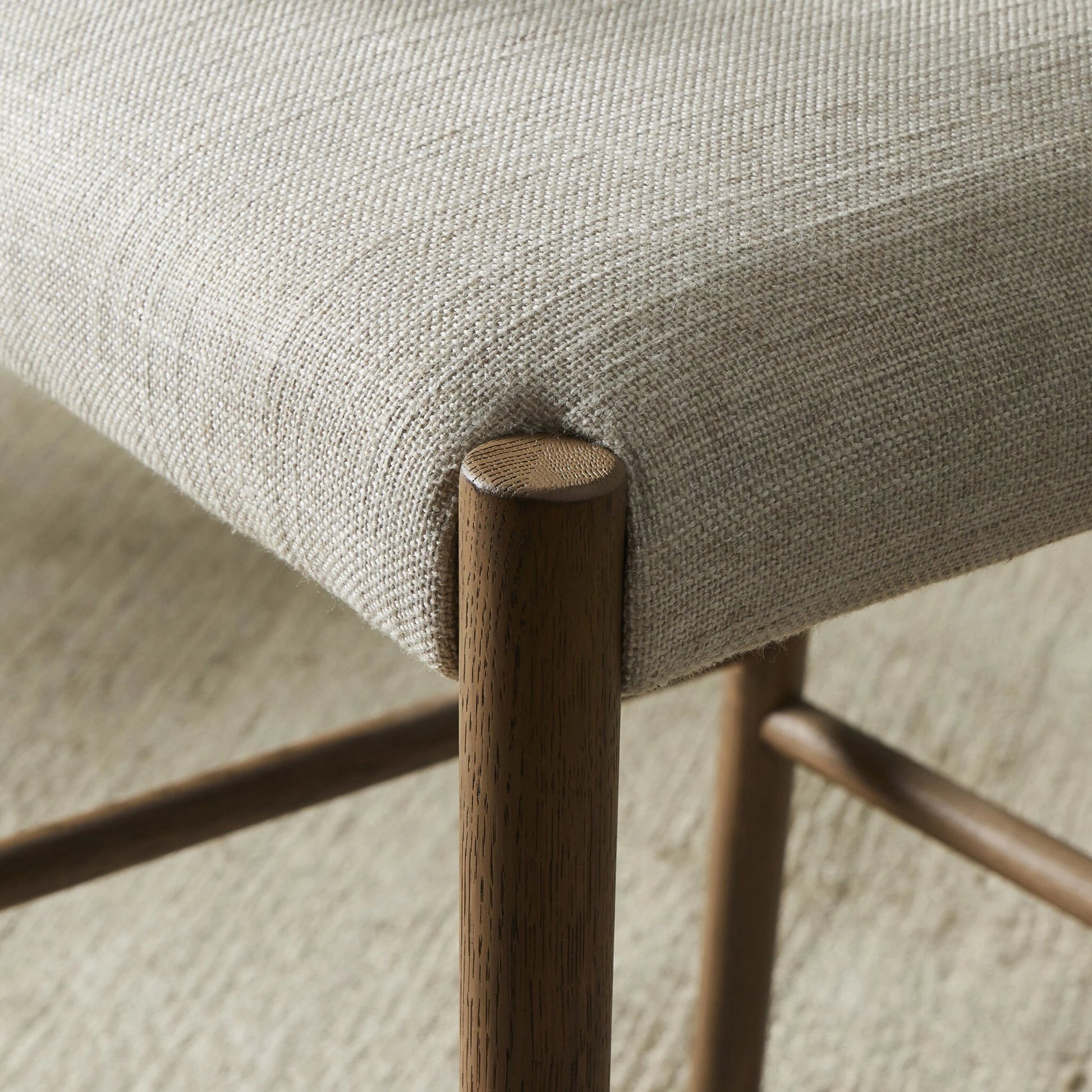 Glenmore Counter Stool by Four Hands in essence natural. Made from 49% viscose (rayon), 22% flax, linen, 18% polyester, 11% cotton, solid oak, 100% polyurethane foam pad in a modern style.