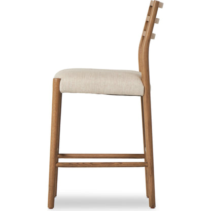 Glenmore Counter Stool by Four Hands in essence natural. Made from 49% viscose (rayon), 22% flax, linen, 18% polyester, 11% cotton, solid oak, 100% polyurethane foam pad in a modern style.