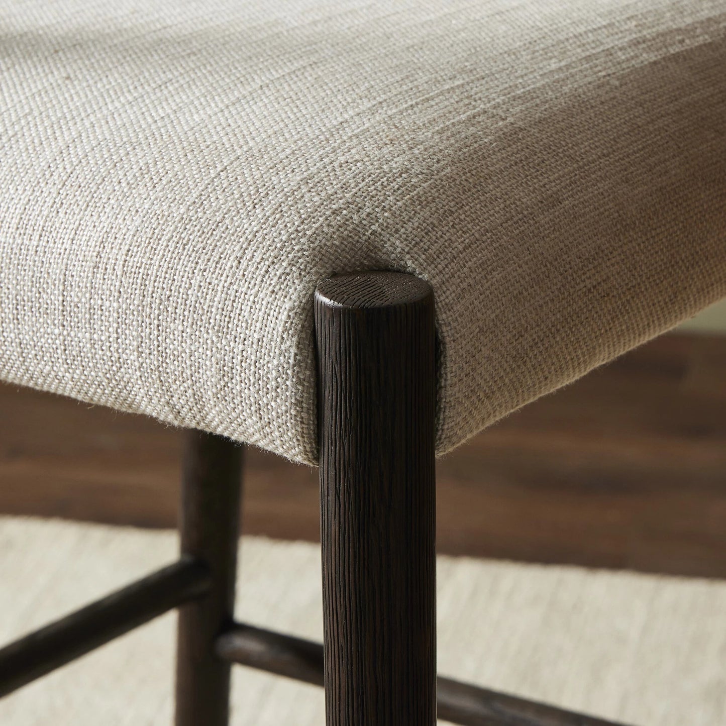 029 SI-2001364 | Closeup | Glenmore Counter Stool by Four Hands in essence natural. Made from 49% viscose (rayon), 22% flax, linen, 18% polyester, 11% cotton, solid oak, 100% polyurethane foam pad in a modern style.