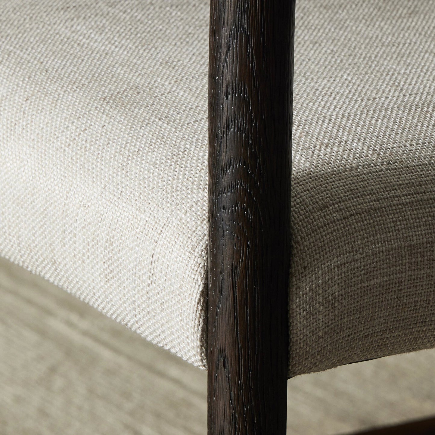 030 SI-2001364 | Closeup | Glenmore Counter Stool by Four Hands in essence natural. Made from 49% viscose (rayon), 22% flax, linen, 18% polyester, 11% cotton, solid oak, 100% polyurethane foam pad in a modern style.