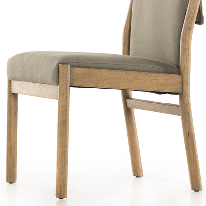 Hito Dining Chair by Four Hands in villa olive and burnished parawood. Made from 62% cotton, 20% flax, linen, 18% viscose (rayon), solid parawood, stainless steel in a transitional style.