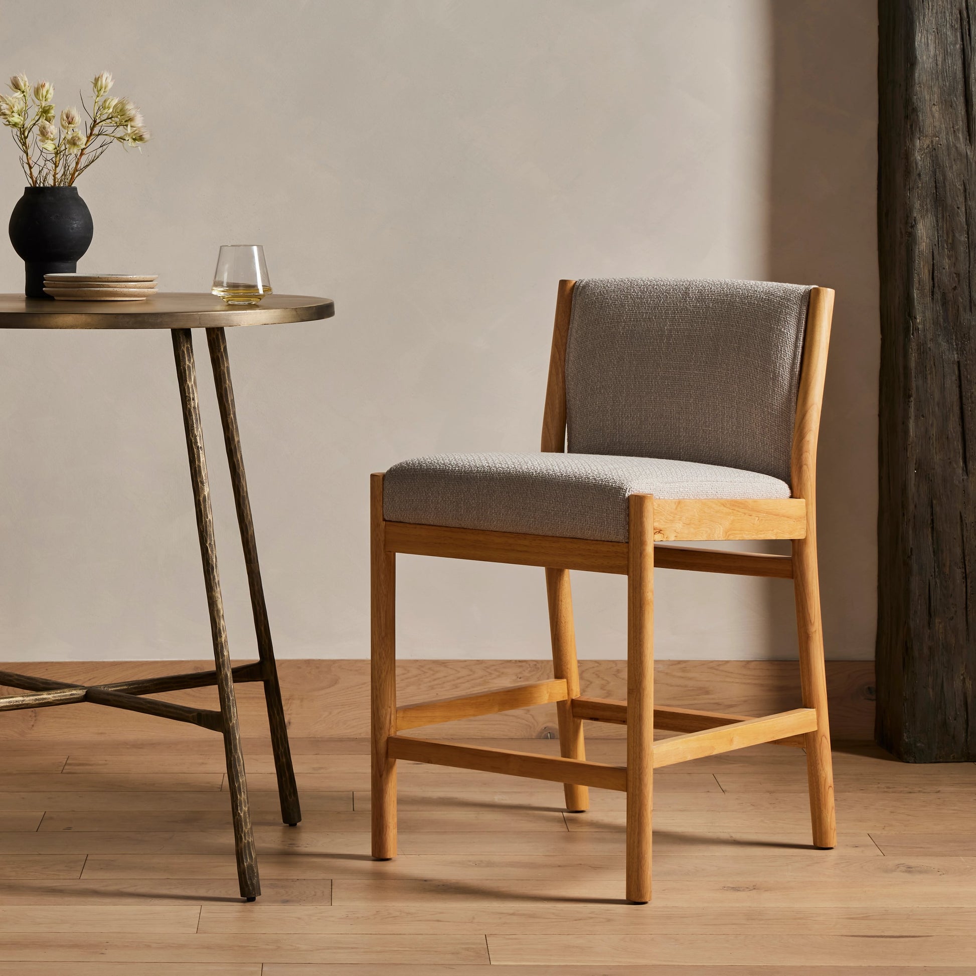 Hito Counter Stool by Four Hands in gibson taupe, smoked natural parawood. Made from 97% polyester, 3% acrylic, solid parawood, stainless steel in a modern style.