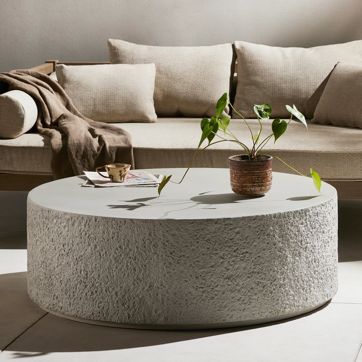 006 SI-2074554 | Lifestyle | Otero Outdoor Round Coffee Table by Four Hands in blanc white, matte white. Made from concrete in a modern style.
