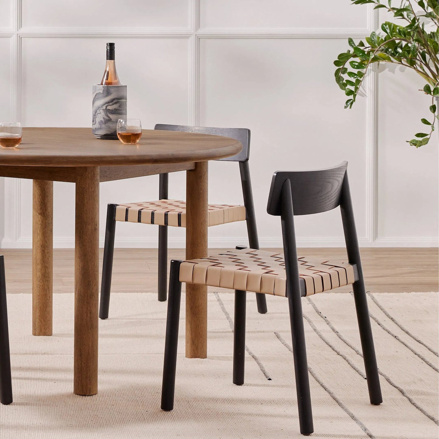 023 SI-1797666 | Lifestyle | Heisler Dining Chair by Four Hands in almond leather blend, black, black veneer. Made from 70% split leather, 30% polyvinyl chloride (pvc), solid ash, ash veneer in a modern style.
