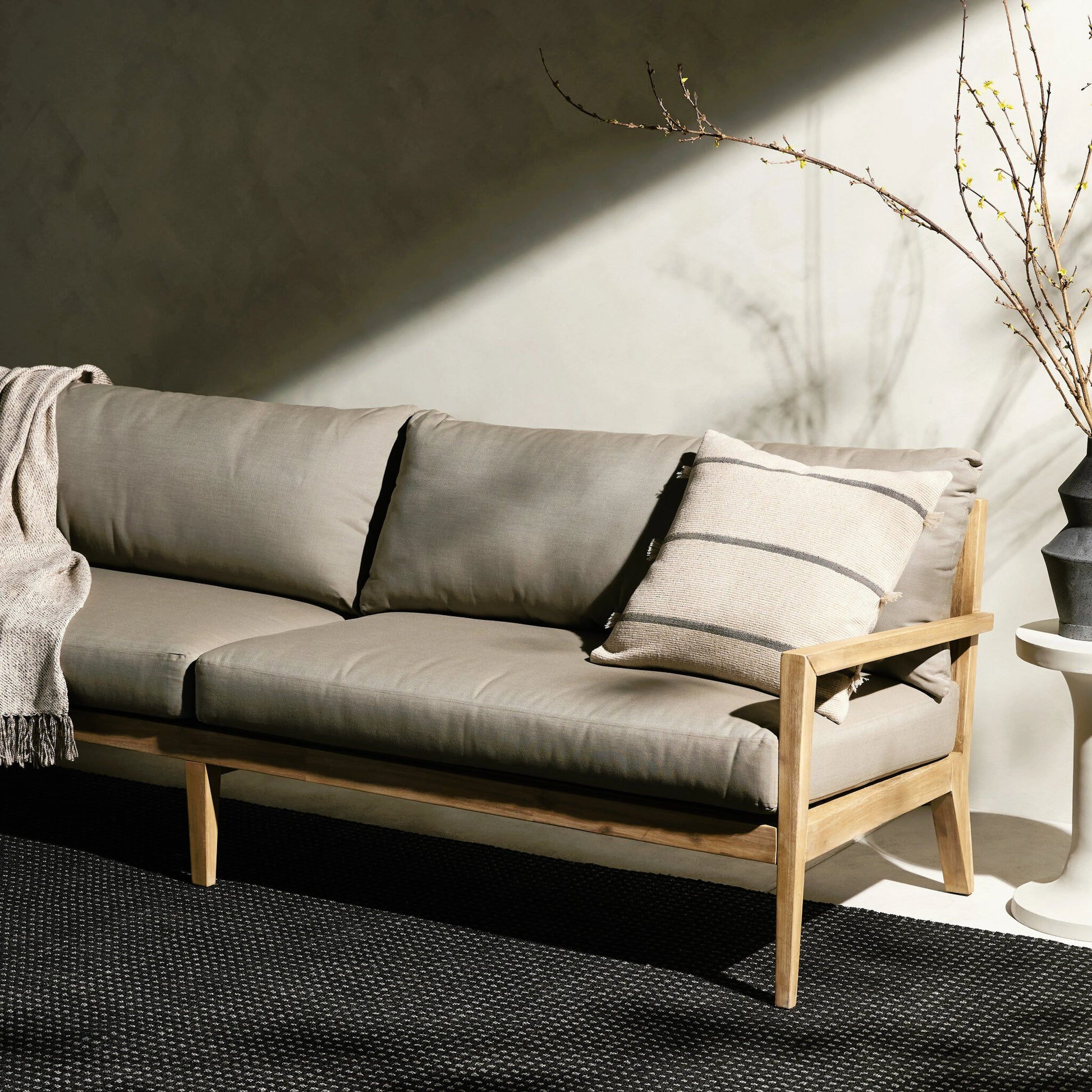 Amaya Outdoor Sofa by Four Hands in royal taupe and natural acacia. Made from solid fsc®-certified acacia, 100% polyester in a modern style.