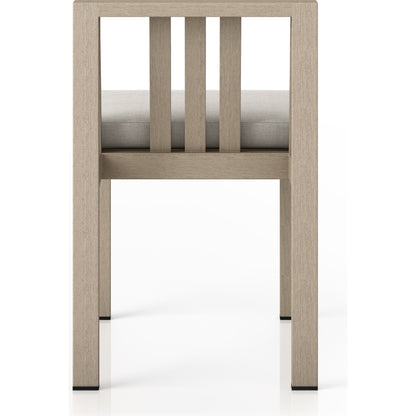 Monterey Outdoor Dining Chair by Four Hands in washed brown. Made from 100% olefin, solid fsc®-certified teak, 91% polyurethane foam pad, 9% polyester fiber batting in a modern style.