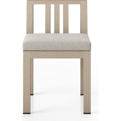 Monterey Outdoor Dining Chair by Four Hands in washed brown. Made from 100% olefin, solid fsc®-certified teak, 91% polyurethane foam pad, 9% polyester fiber batting in a modern style.