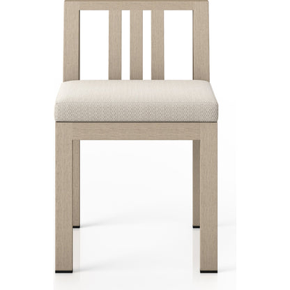 Monterey Outdoor Dining Chair by Four Hands in washed brown. Made from 100% olefin, solid fsc®-certified teak, 91% polyurethane foam pad, 9% polyester fiber batting in a modern style.
