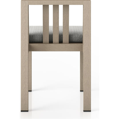 Monterey Outdoor Dining Chair by Four Hands in washed brown. Made from 100% olefin, solid fsc®-certified teak, 91% polyurethane foam pad, 9% polyester fiber batting in a modern style.