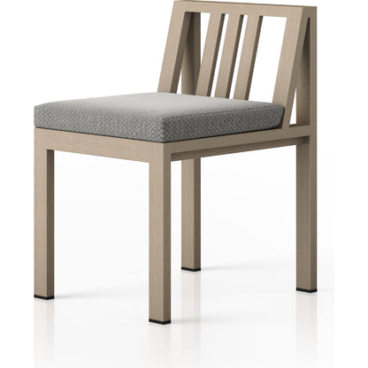 Monterey Outdoor Dining Chair by Four Hands in washed brown. Made from 100% olefin, solid fsc®-certified teak, 91% polyurethane foam pad, 9% polyester fiber batting in a modern style.